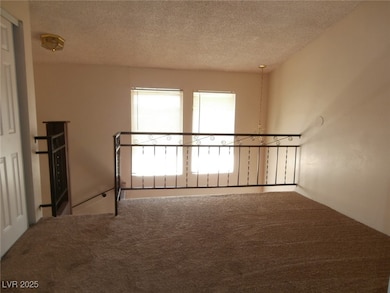 Spare room with carpet flooring and a textured cei