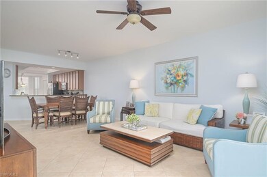 Living room with light tile floors, ceiling fan, a