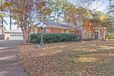 View of front of property featuring brick siding and driveway