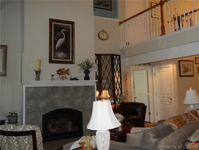Living Room showing fireplace from upstairs balcon