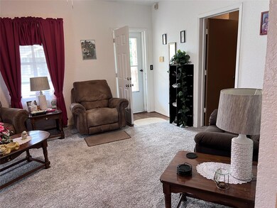 Living room with carpet flooring and plenty of nat