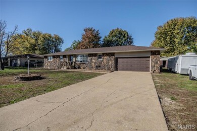 Ranch-style house featuring stone siding, concrete driveway, a front lawn, and a garage