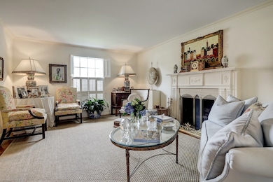 Left unit: Another view of the living room. Oversized window with shutters. Living and dining rooms open to one another.