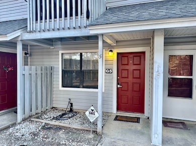 Entrance to property with a shingled roof