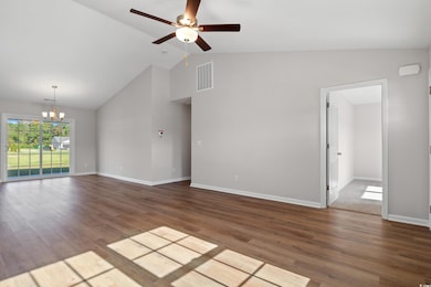 Unfurnished living room featuring ceiling fan with