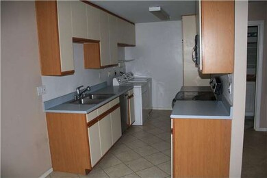 Washer and dryer located next to kitchen.