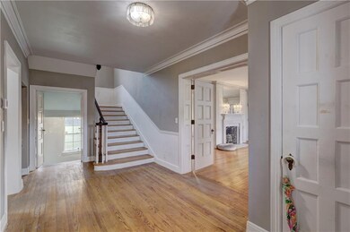 Large foyer with grand, 2-landing staircase.  Livi