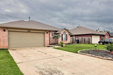 Ranch-style house with brick siding, a garage, a shingled roof, and concrete driveway