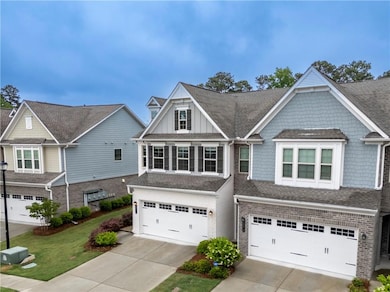 View of front of home featuring concrete driveway,