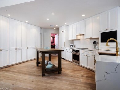 Kitchen featuring oven, white cabinets, light wood finished floors, recessed lighting, and electric stovetop