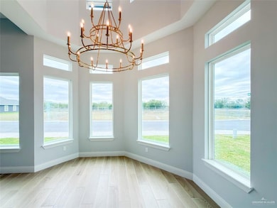 Unfurnished dining area featuring light wood-style flooring and baseboards