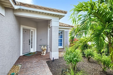 Doorway to property featuring a tile roof and stuc