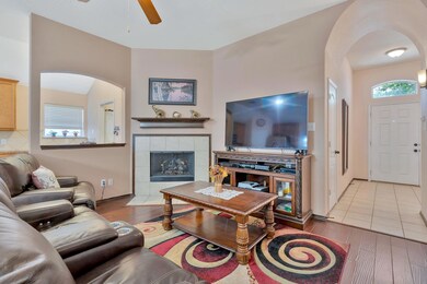 Living room with a tiled, wood burning  fireplace