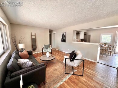 Living room with light hardwood / wood-style floor