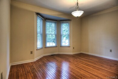 Formal dining room with bay window, hardwoods, and
