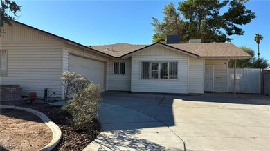Ranch-style house featuring driveway, a shingled roof, and an attached garage