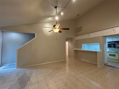 Kitchen bar opens to the living area with stairs g