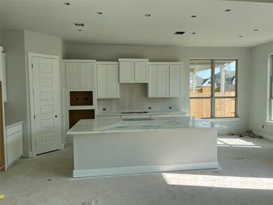 Kitchen featuring a kitchen island, white cabinet