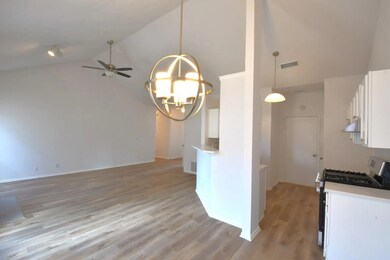 Kitchen featuring stainless steel gas range, high