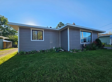 View of side of home with a lawn