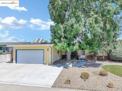 View of front of home featuring a garage and concrete driveway