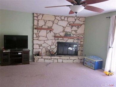 Living room fireplace with three mantles.