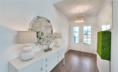 Entryway featuring french doors and wood finished floors