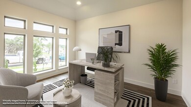 Home office with baseboards and wood finished flo