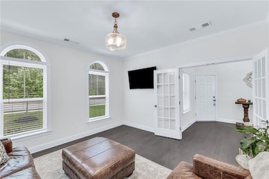 The study/office boasts arched windows and dual fr