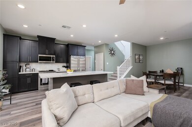 Living room with visible vents, recessed lighting,