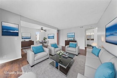 Living area featuring wood finished floors, basebo