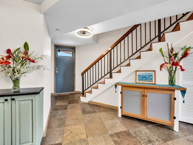 Entry foyer with the powder room on the right as you enter. Stairway takes you to the two primary suites above.