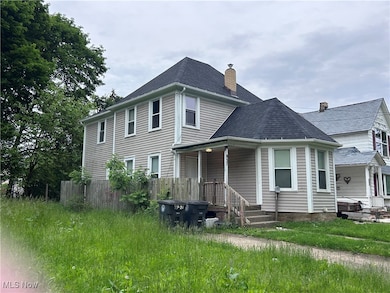 View of front of property with a chimney and roof with shingles