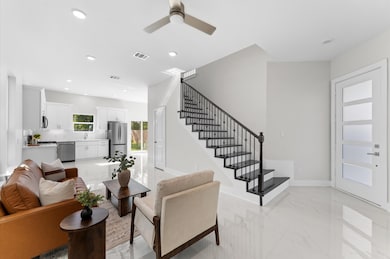 Welcoming entry with sleek tile flooring and conte