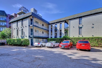 View of property featuring uncovered parking