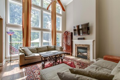 The Family Room features a 20' ceiling and a wall of windows overlooking the lovely backyard.  Also included is surround sound.