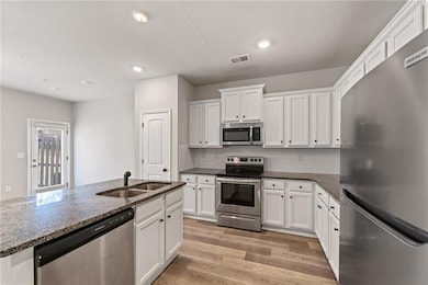 Kitchen with stainless steel appliances, visible v