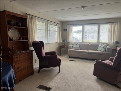 Living room with a textured ceiling and carpet flo