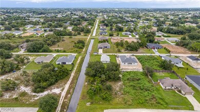 Aerial view of property and surrounding area featuring nearby suburban area