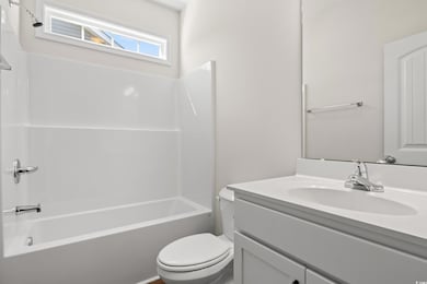 Full bathroom with toilet, shower / tub combinatio