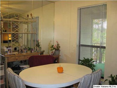 DINING AREA WITH A WINDOW TO THE BALCONY.