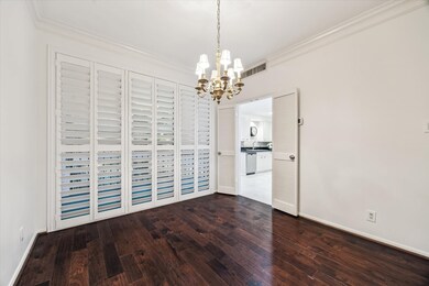 This room features rich dark wood flooring and bri