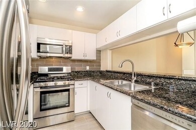 MODERNIZED KITCHEN WITH S.S. APPLIANCES, GRANITE COUNTERS TILE BACKSPLASH AND UPGRADED TILE FLOORS