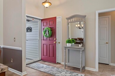 Foyer with tile patterned floors and an inviting c