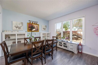 Dining space featuring dark wood-type flooring, ba