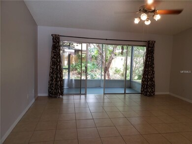 Spacious living room with view to screened in pati