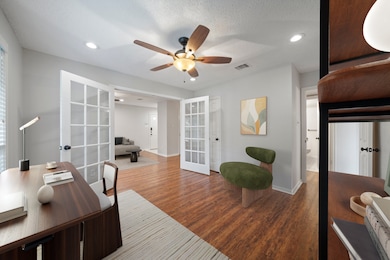 Versatile flex room with French doors and direct access to the living area. Perfect as an office, den, or optional second bedroom.