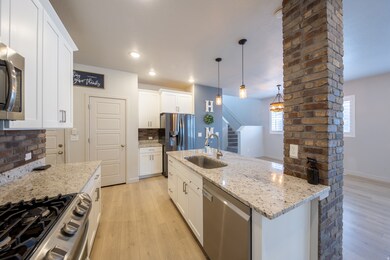 Walk through kitchen area with large island bar with sink.