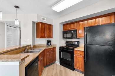 Kitchen with pendant lighting, light hardwood / wo