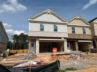 View of front facade featuring brick siding and a garage